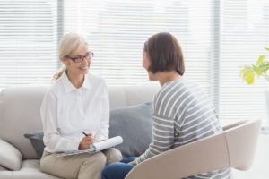a woman discusses treatment options with an addiction treatment specialist and determines that a php is right for her needs